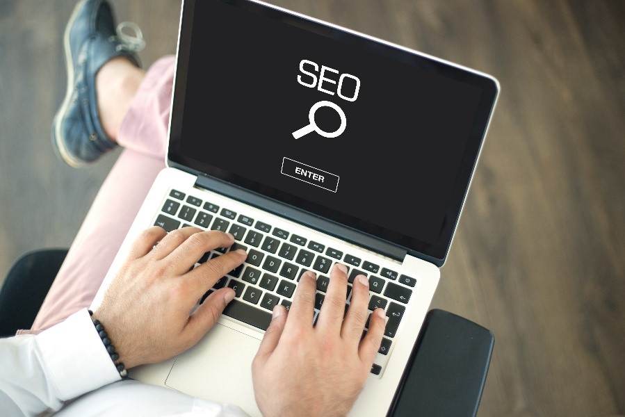 Man searching for SEO on laptop